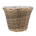 A lovely brown wicker plant holder with an inner lining. 