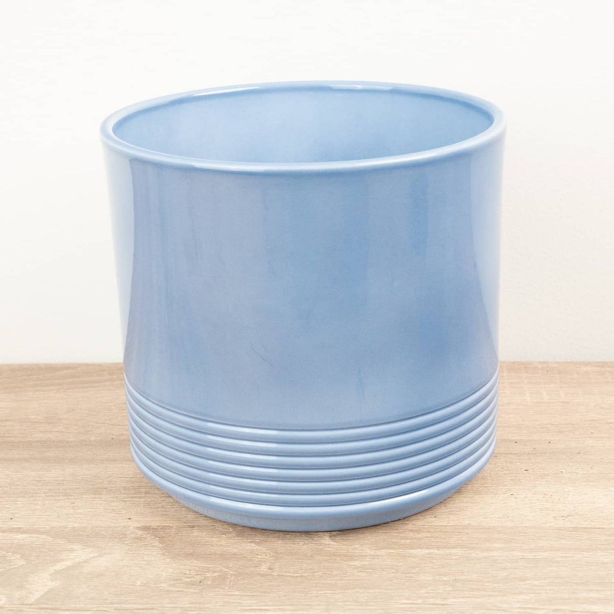 A stunning Munich 'Blue Gloss' Ceramic houseplant pot, admired for its modern pastel colour, gentle curves and distinct 'lined' lower potion that is sure to captivate & inspire! A superb pot that is great for gifting!