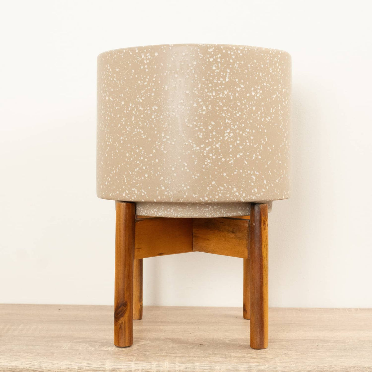 A stunning Valetta 'Speckled Caramel' pot with an accompanying stand. Excellent for showcasing all sorts of houseplant varieties, their natural cream speckled style and light brown wooden stand are sure to inspire wherever they go! Available whilst stocks last.