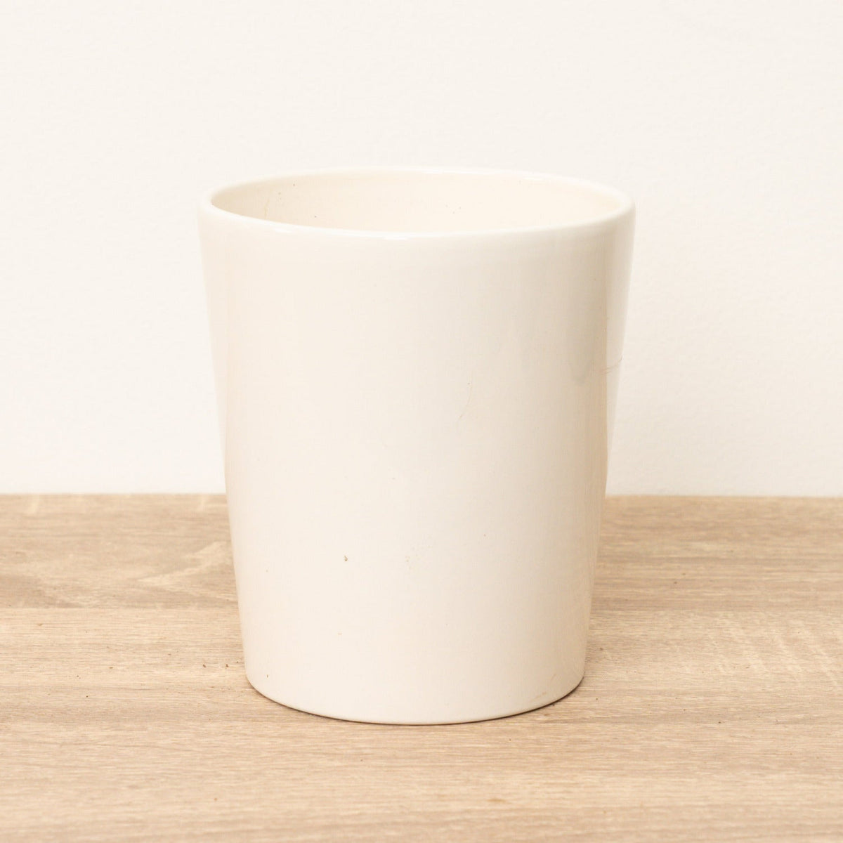 A stunning 'Patience' plant pot in a white colour wave, offering a timeless minimalist appeal.