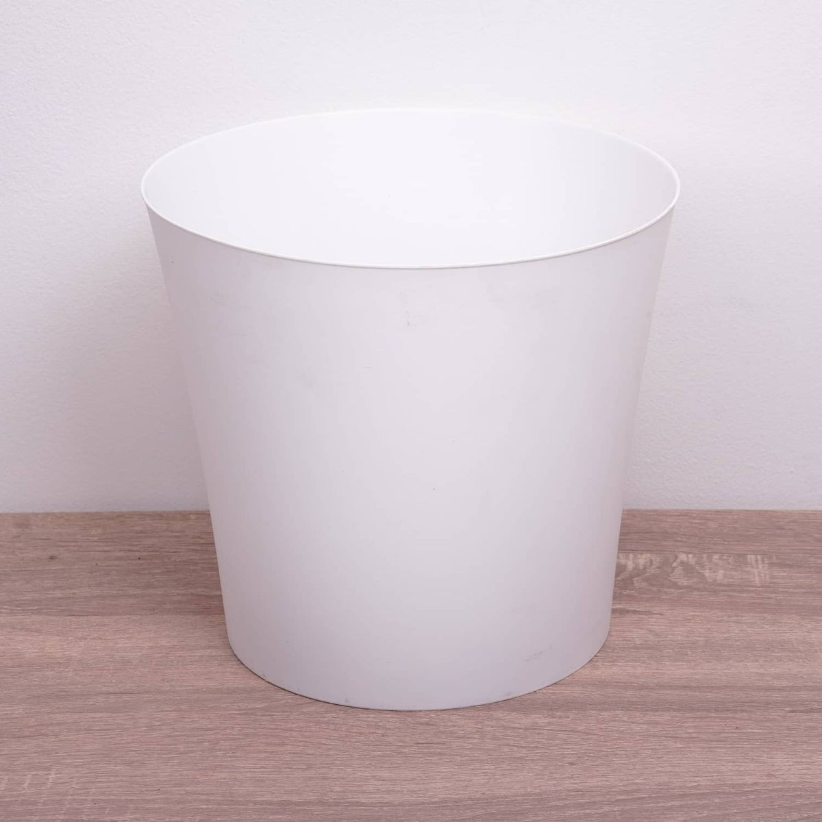 A superb, minimalist white plastic plant pot cover - perfect for showcasing your plant and keeping it comfortable. 