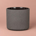 Mondo pot in Basalt Stone with a charcoal-grey speckled finish, dark rim and rounded base