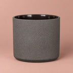 Mondo pot in Basalt Stone with a charcoal-grey speckled finish, dark rim and rounded base