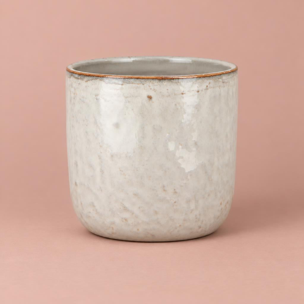 White Iron Stone pot with grey mottling, earthy speckles, a thin brown rim and a rounded base