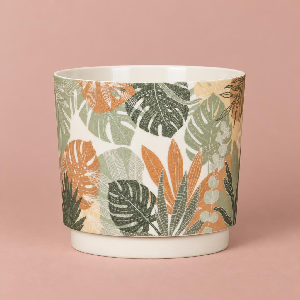 Cylindrical Plano pot with a cream background and overlapping green, peach and brown leaf motifs