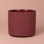 Mondo Burgundy Stone pot with light speckles, a darker rim and a gently rounded base