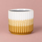 Kiri Pot with vertical ribbing and a glossy glaze graduating from white at the top to yellow at the base