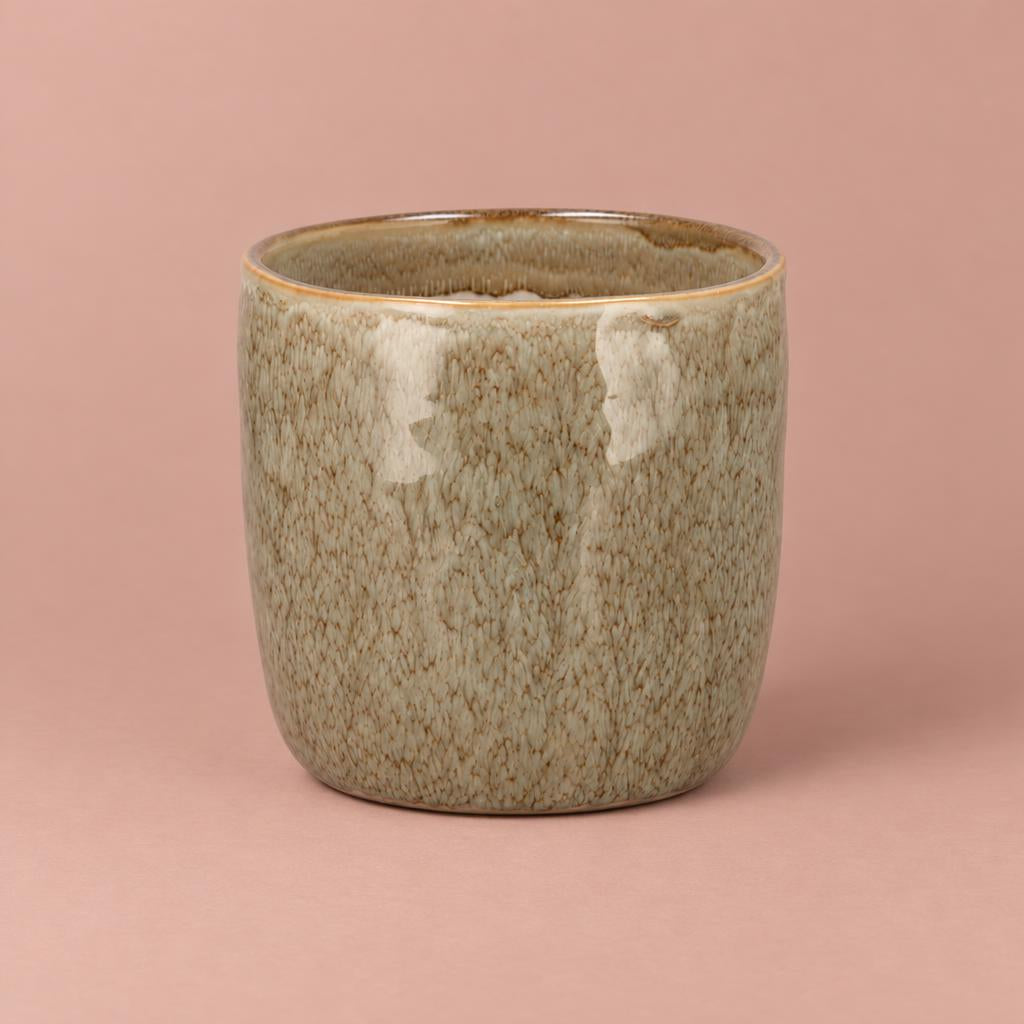 Sand-coloured Iron Stone ceramic pot with a rounded shape, glossy taupe glaze and caramel-toned rim