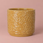 Yellow Arbor ceramic pot with a glossy glaze and embossed trailing-leaf pattern