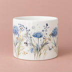 Floral Fiori ceramic pot with a glossy white background and blue hydrangea, foliage and butterfly decoration