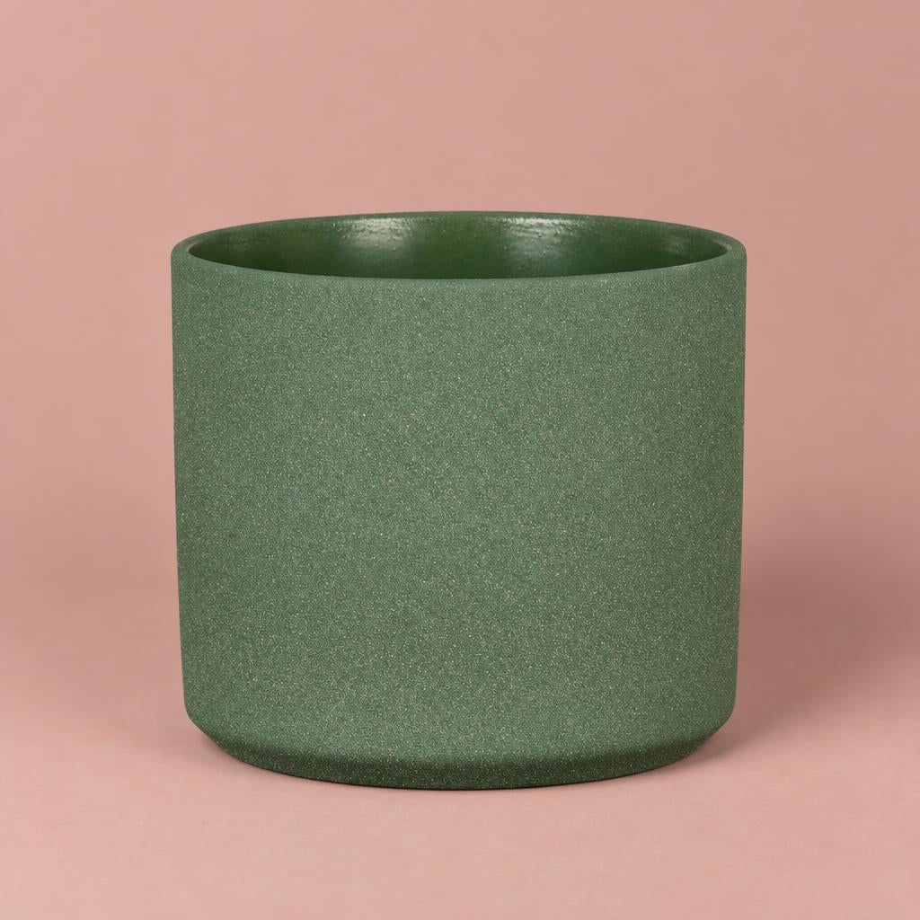 Mondo pot in Moss Stone with pale speckling, a darker rim and a gently rounded base