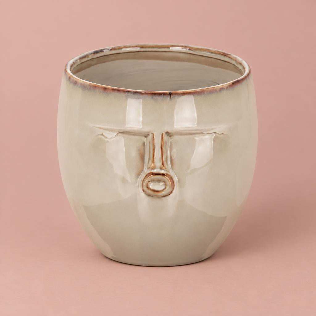 Expressions ceramic pot with a glossy warm beige glaze, rounded shape and raised face detail