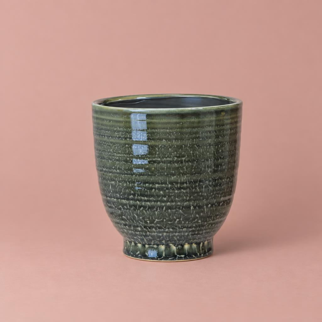 Green Fergus Pot with horizontal detailing, tapered sides and a raised base