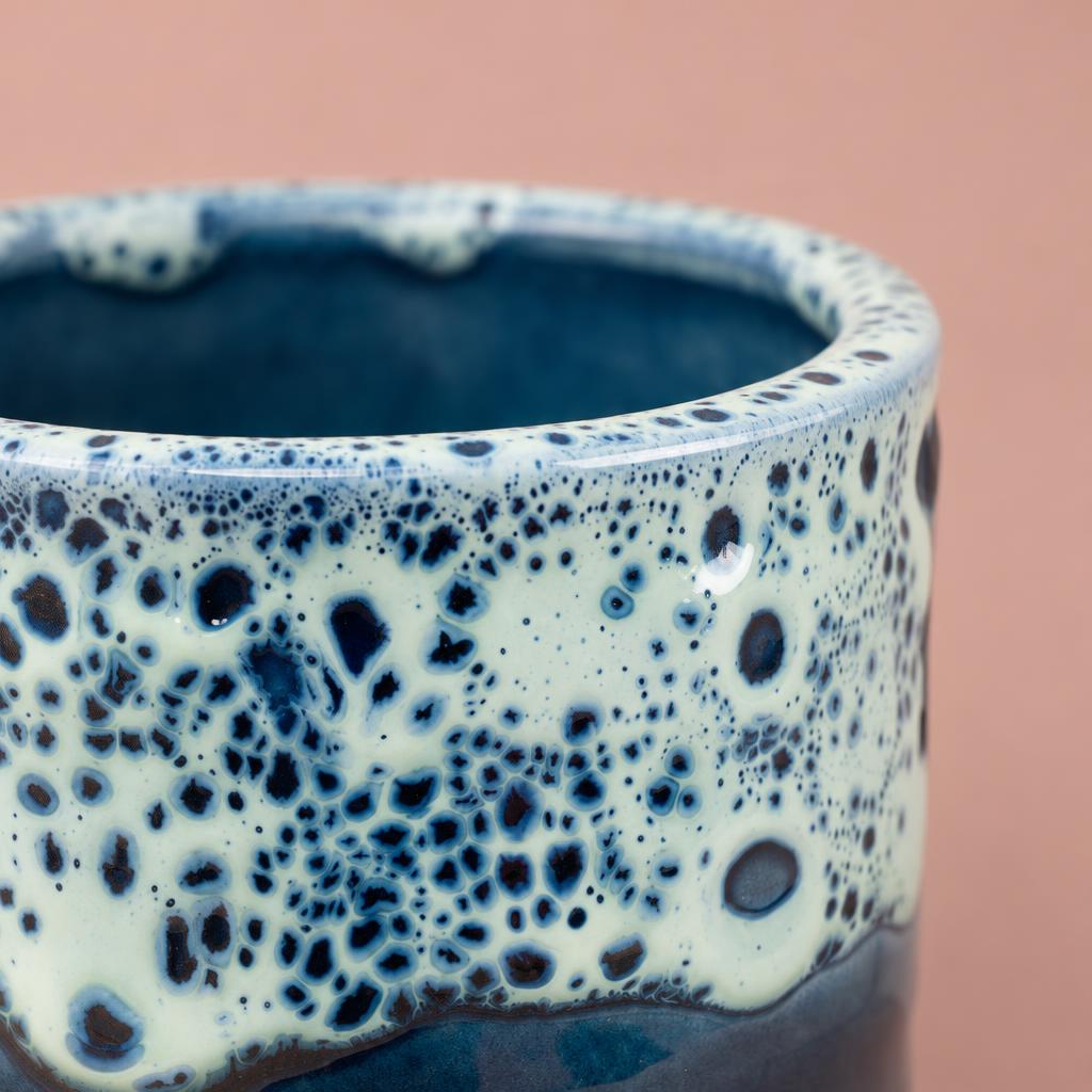 Sapphire plant pot with crater-like decorative patterns