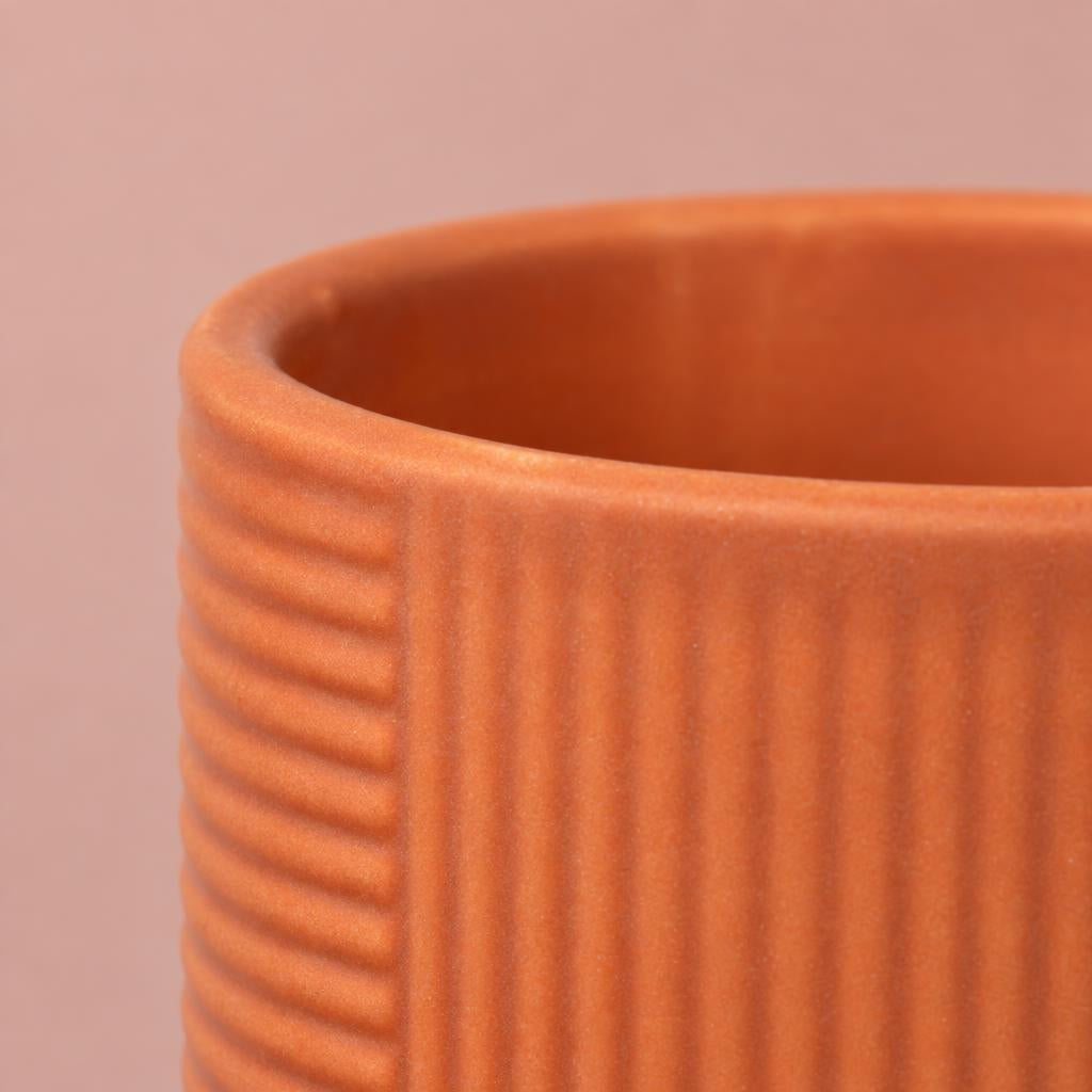 Tangerine Grooves plant pot with terracotta-orange colouring and linear decoration