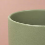 Single Sage Green Lisbon ceramic plant pot with a curved shape