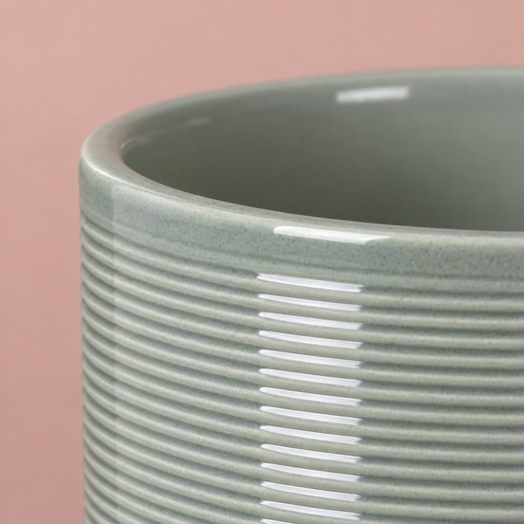Rounded sage green ceramic plant pot with horizontal ribbed detailing