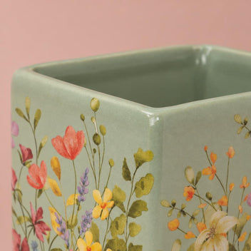 Floral Portuguese Pot with a floral pattern against a soft green background