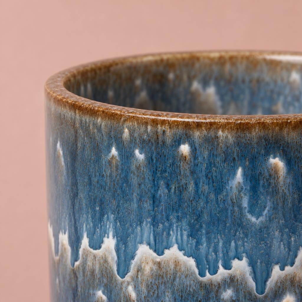 Blue and cream cylindrical Dora Reactive Stripe pot with a textured glaze