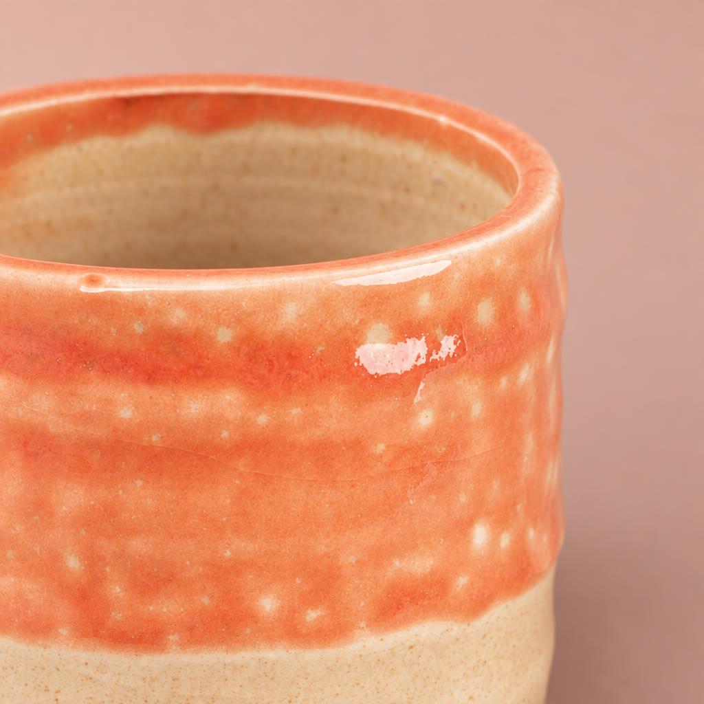 Titan plant pot with orange colour waves and decorative feet
